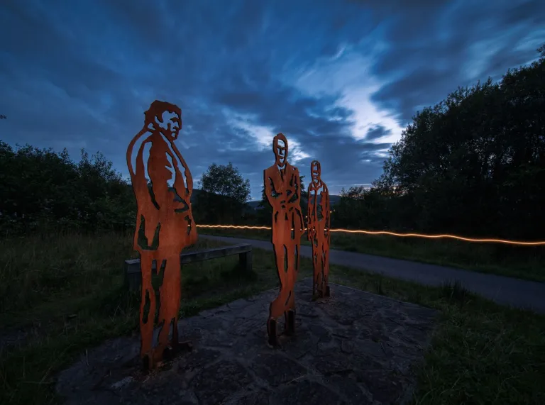Copper statues of Richard Burton on a walking trail