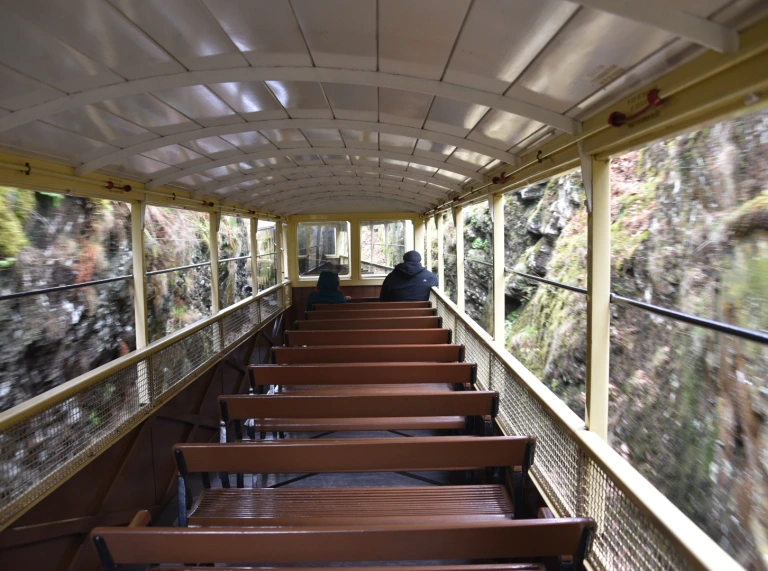 Inside a moving carriage of a steam train.