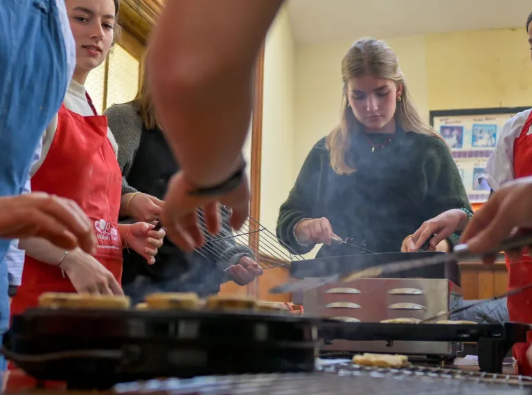 Group of ladies making welshcakes in a workshop.