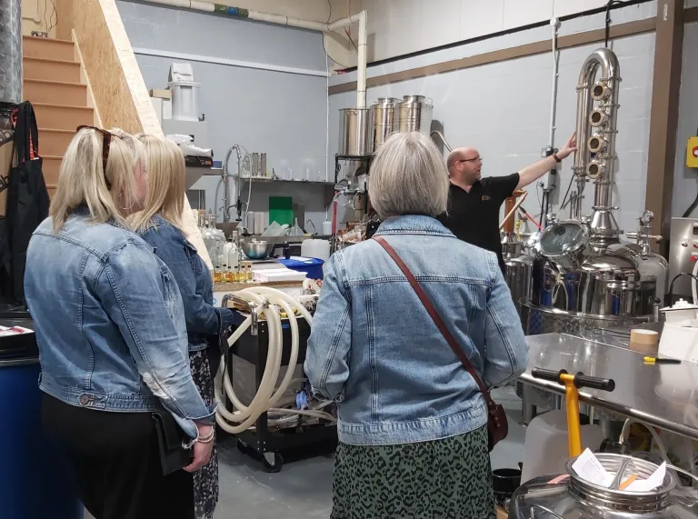 Group of people on a tour of a distillery