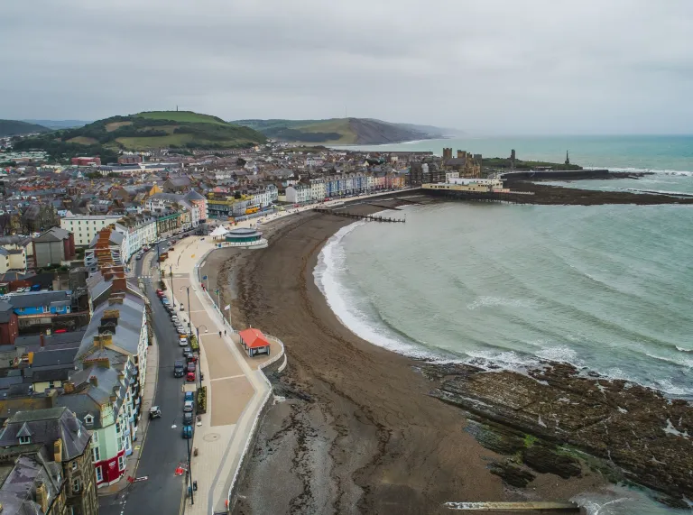 A coastline and town taken from the top of a cliff.