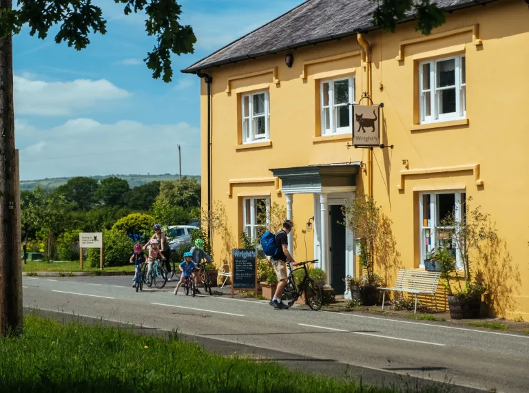 Family of cyclists stopping at a coffee shop.