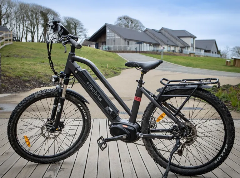 An electric bike outside a lake visitor centre.