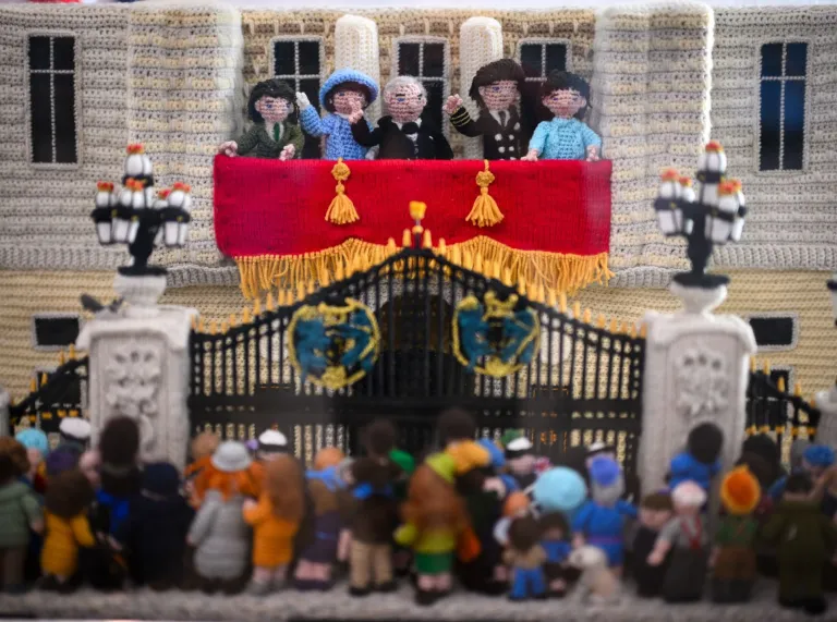 The Royal Family on a palace balcony waving to crowds all made from wool.