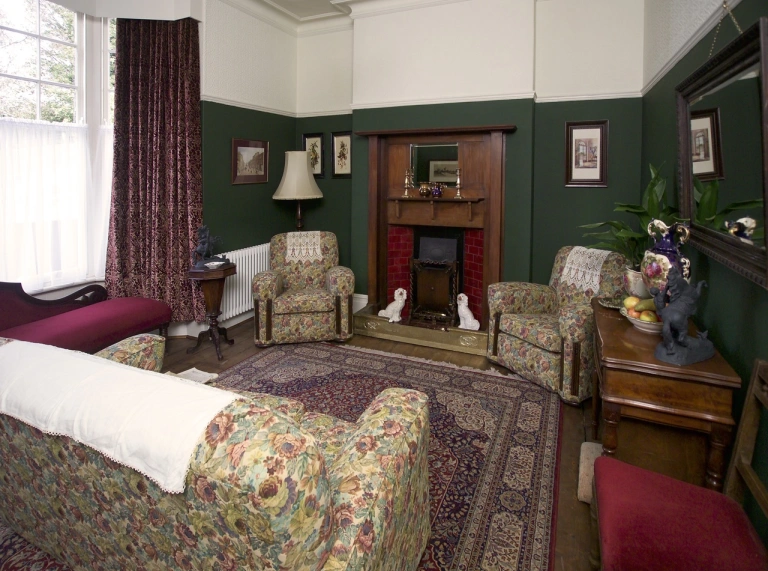 An historic living room of a famous writer with a feature fireplace.