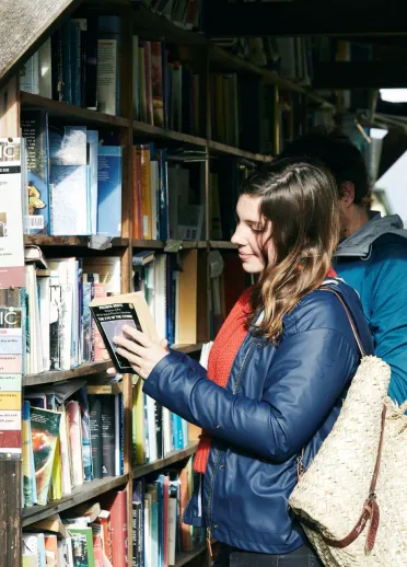 A lady looking at books in Hay-on-Wye.