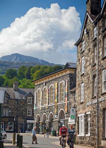 Stone buildings in Eldon Square with Cadair Idris mountain in the background.