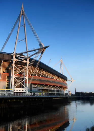 A side view of Principality Stadium sitting alongside the river.