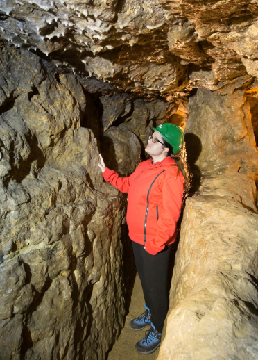 A woman in a tunnel in Great Orme Mines.