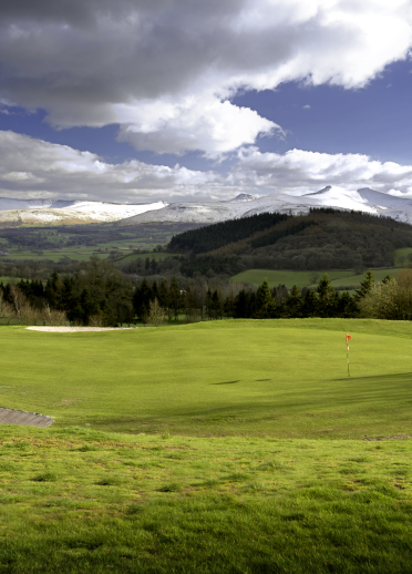 Dramatic mountains seen from one of the greens at Cradoc Golf Club.
