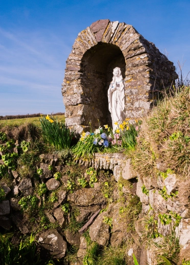 Shrine at St Non's Chapel with daffodils.