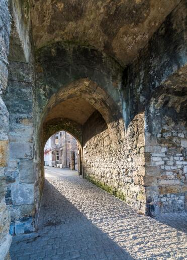 The arched gateway to the town through the stone castle wall.