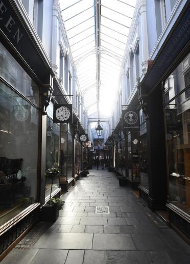 The long corridor and glass ceiling in a Victorian shopping arcade.