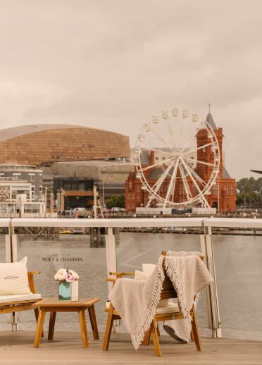 A terrace at a hotel overlooking the landscape of Cardiff bay.