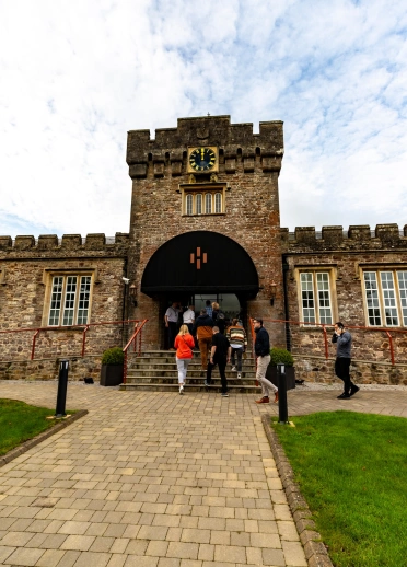 Group of people on tour walking in to a gin making distillery.