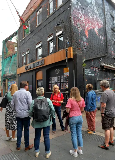 Group of people on a food tour in a city centre.
