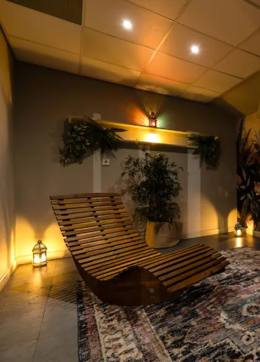 Two wooden curved relaxation beds in a luxury spa.