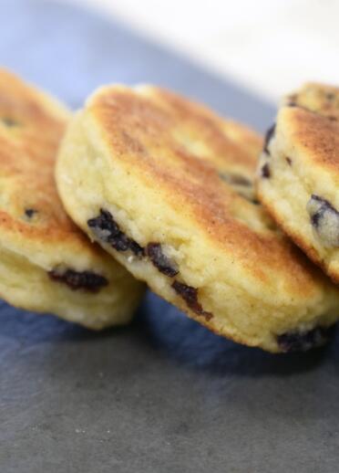 A tray of Welsh cakes, (flat scones with dried fruit).