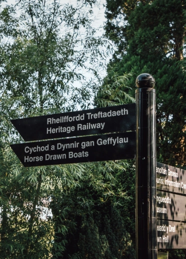 A signpost showing directions to tourist attractions.