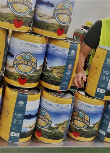 A workman stacking kegs of beer at Gower Brewery, Swansea.