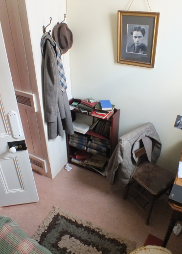 interior of a bedroom with a written desk and photo, shot from above.