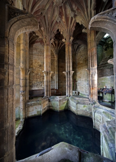 Historical well inside an ornate chapel.