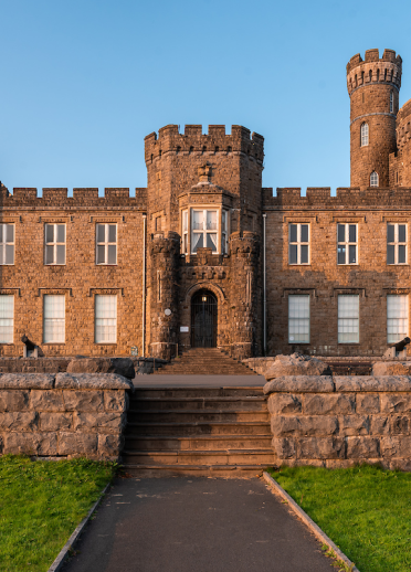 Exterior of a grand castellated mansion.