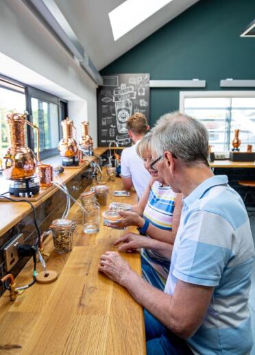 Visitors on a tasting tour at a distillery.