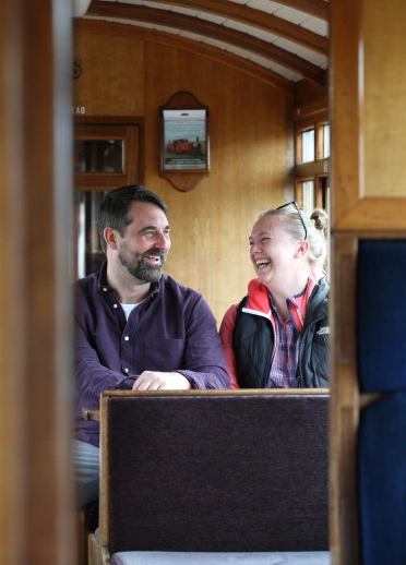 Passengers in the carriage of a steam train.