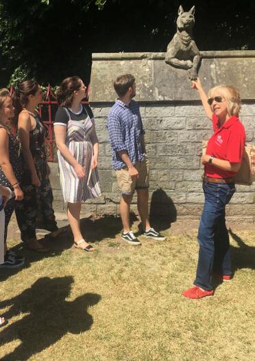 A group of people on a Loving Welsh Food tour by the Animal Wall, Cardiff Castle.