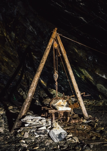 Tree trunks formed into a rig and pulley to lift slate onto a wagon.