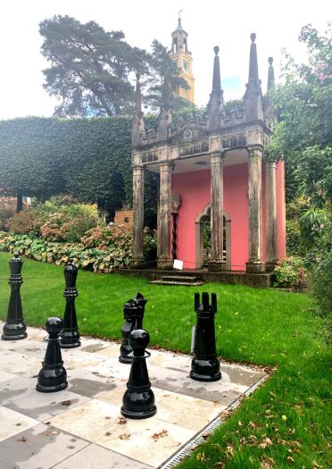 A giant chess board in the gardens of an Italianate village.