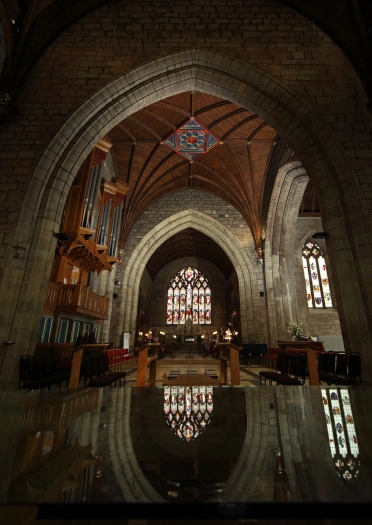 Arches and stained glass windows in a cathedral.