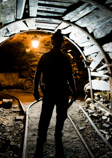 The silhouette of a miner in an underground tunnel of the mine.
