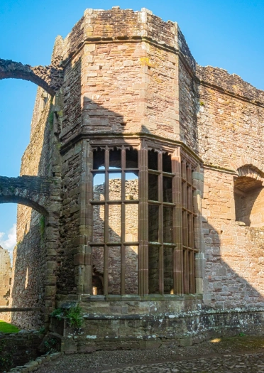 A tower with a grand bay window of a derelict castle.