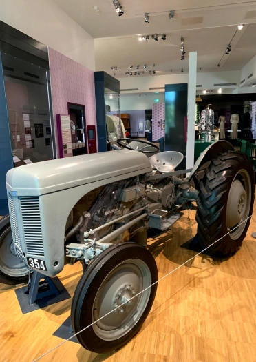 An old tractor displayed in an exhibition hall at St Fagans.