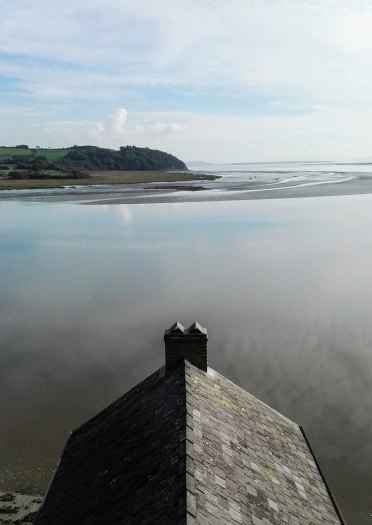 Views on an estuary from the top of the roof of a boathouse.