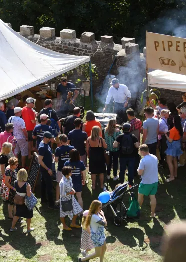 Lots of people gathered around the food stalls at Abergavenny Food Festival.