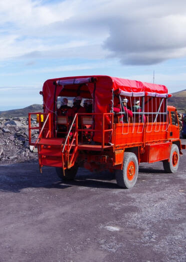 The big red truck taking visitors on the Penrhyn Quarry Tour at Zip World.