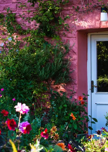 A pink house adorned with flowers.
