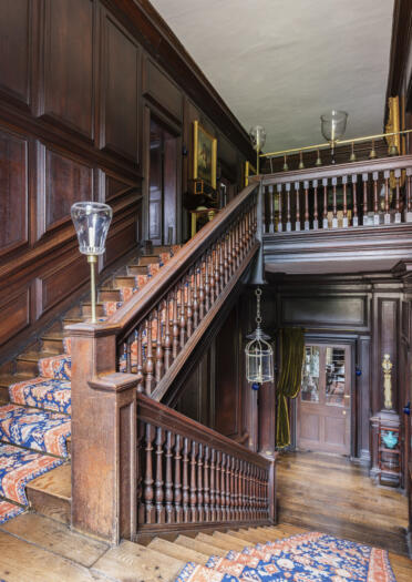 Wooden staircase and room with wooden panels at Erddig.