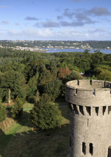 Aerial view of the tower at Penrhyn Castle and Menai Strait beyond.