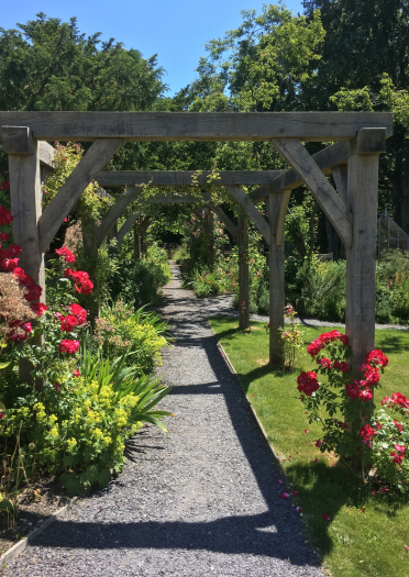 The garden with flowers and wooden trellises at Nantclwyd y Dre.