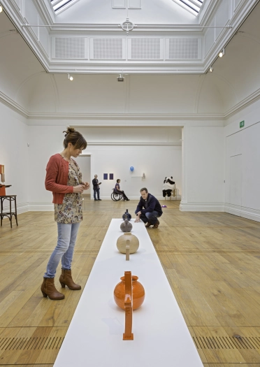 people looking at displays in art gallery.