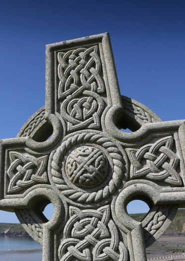 Celtic cross with views of the coastline.