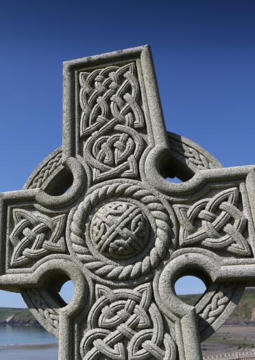 Celtic cross with views of the coastline.