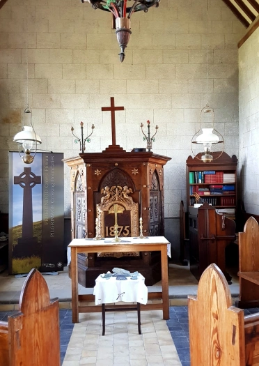 View from the pews to the altar inside a chapel.