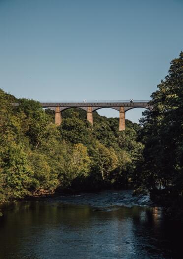 View of an aqueduct from the river below.