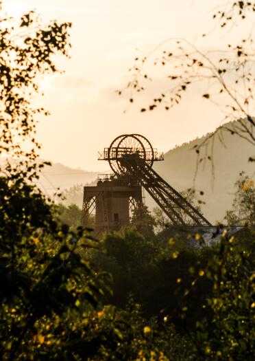 a winding wheel in a former colliery at sunrise.