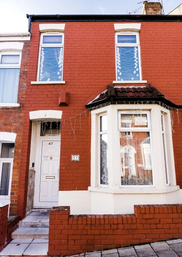 A red bricked terraced house.
